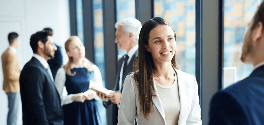 A professional mingles at a conference with cohorts.